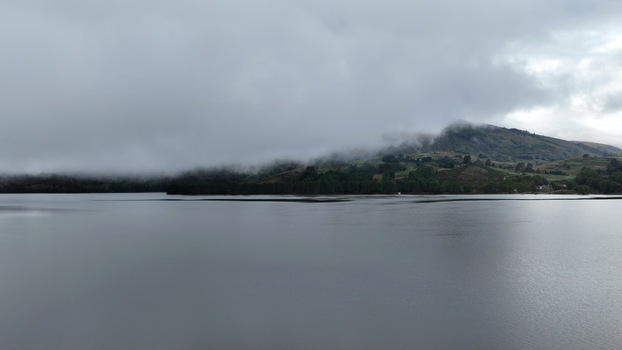 Aerial view of Corani Lake surrounded by rolling hills and low hanging clouds in Chapare Cochabamba Department Bolivia. Aerial view of Corani Lake surrounded by rolling hills and low hanging clouds in Chapare Cochabamba Department Bolivia.