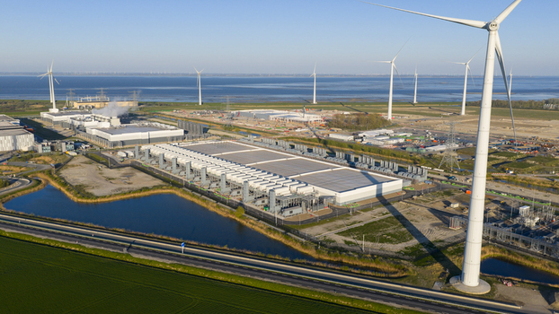 Drone view of a hyperscale data center in Eemshaven showing cloud computing server infrastructure cooling systems backup power and digital connectivity. Drone view of a hyperscale data center in Eemshaven showing cloud computing server infrastructure cooling systems backup power and digital connectivity.