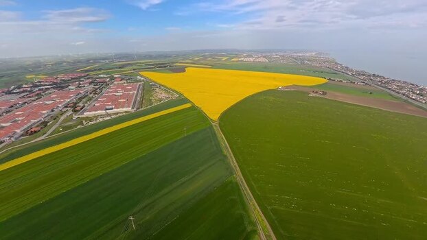 Aerial view of yellow canola fields and industrial area Turkey.