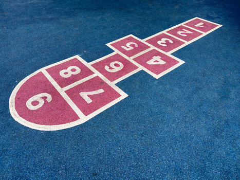 View of a pink hopscotch court with white numbers painted on a blue rubberized playground surface in Sariyer Istanbul Turkiye.