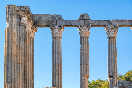 Evora Portugal 09 September 2026 View of the ancient Roman Temple of Evora with its weathered stone columns and Corinthian capitals set against a clear blue sky. Evora Portugal 09 September 2026 View of the ancient Roman Temple of Evora with its weathered stone columns and Corinthian capitals set against a clear blue sky.