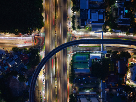 Aerial view of Jalan Gatot Subroto highway intersection at night with light trails from moving vehicles in Kecamatan Mampang Prapatan Daerah Khusus Ibukota Indonesia. Aerial view of Jalan Gatot Subroto highway intersection at night with light trails from moving vehicles in Kecamatan Mampang Prapatan Daerah Khusus Ibukota Indonesia.