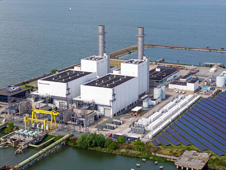 Aerial view of the Maxima plant with its power station buildings industrial infrastructure and large solar panel array situated on the waterfront in Lelystad Flevoland Netherlands. Aerial view of the Maxima plant with its power station buildings industrial infrastructure and large solar panel array situated on the waterfront in Lelystad Flevoland Netherlands.