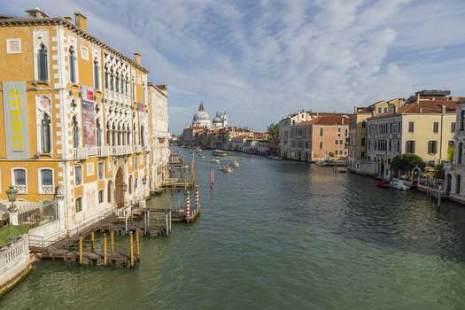 Venice Italy 21 September 2026 View of the Grand Canal with historic buildings and the Basilica di Santa Maria della Salute under a clear blue sky. Venice Italy 21 September 2026 View of the Grand Canal with historic buildings and the Basilica di Santa Maria della Salute under a clear blue sky.