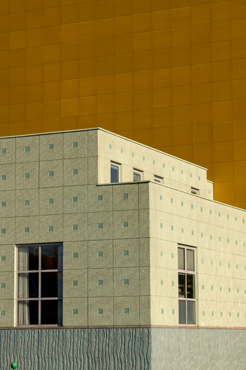 Groningen Netherlands 23 April 2024 View of the modern architecture of the Groninger Museum featuring a golden tiled tower and a patterned facade under bright daylight. Groningen Netherlands 23 April 2024 View of the modern architecture of the Groninger Museum featuring a golden tiled tower and a patterned facade under bright daylight.