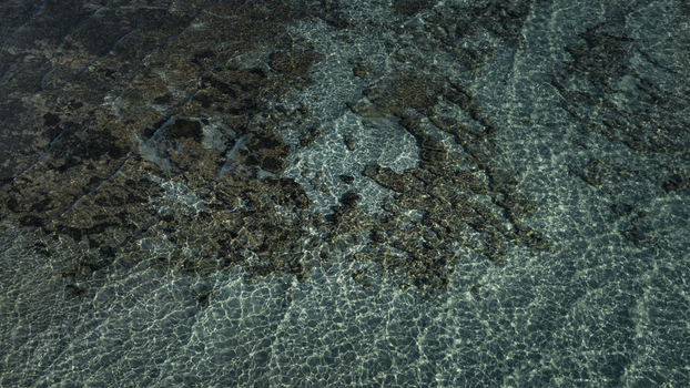 Aerial view of the clear blue water and intricate sand and rock patterns on the seabed in Denham Western Australia Australia. Aerial view of the clear blue water and intricate sand and rock patterns on the seabed in Denham Western Australia Australia.