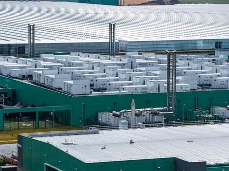 Aerial view of the Agriport A7 industrial facility with modular white units on the roof green walls and expansive greenhouses in Middenmeer Noord Holland Netherlands. Aerial view of the Agriport A7 industrial facility with modular white units on the roof green walls and expansive greenhouses in Middenmeer Noord Holland Netherlands.
