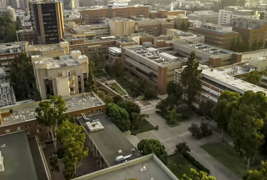 Aerial view of the UCLA Campus featuring brick buildings courtyards and lush trees in Westwood California United States.