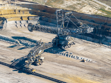 Aerial view of the Tagebau Welzow Sud brown coal open pit mine with a massive bucket wheel excavator operating in the industrial landscape of Spremberg Brandenburg Germany. Aerial view of the Tagebau Welzow Sud brown coal open pit mine with a massive bucket wheel excavator operating in the industrial landscape of Spremberg Brandenburg Germany.