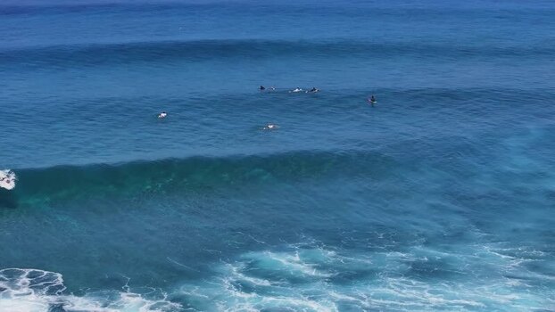 Aerial view of surfers waiting for waves in the ocean Maldives.