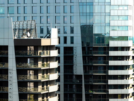 Aerial view of modern residential real estate with glass facades balconies and geometric architectural details in Katowice Silesian Voivodeship Poland.