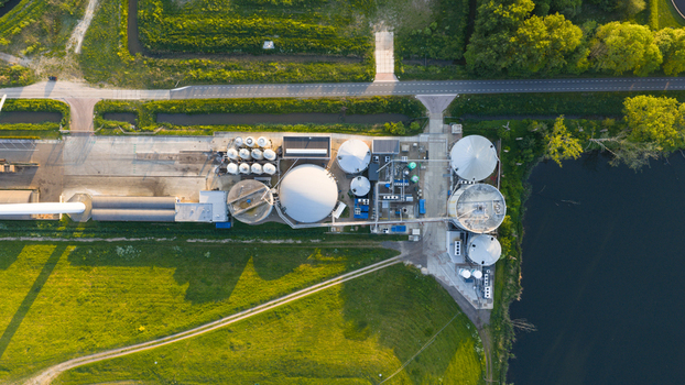 Aerial view of Wabico BV industrial facility and biogas plant featuring large circular storage tanks and complex piping systems in Waalwijk Noord Brabant Netherlands.
