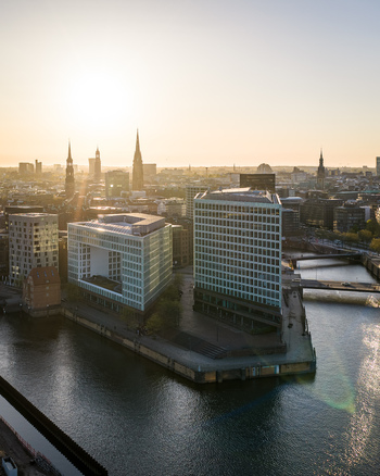 Aerial view of the Speicherstadt district and modern office buildings at Ericusspitze with the historic city skyline at sunset in Hamburg Hamburg Germany. Aerial view of the Speicherstadt district and modern office buildings at Ericusspitze with the historic city skyline at sunset in Hamburg Hamburg Germany.