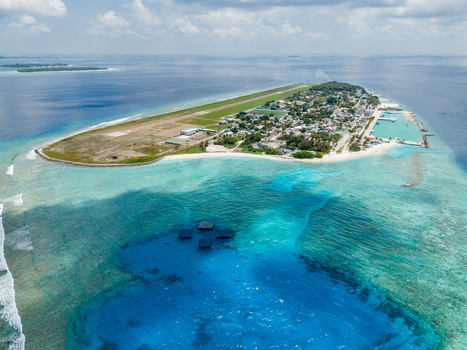 Aerial view of SolarSea floating solar power plant by Swimsol near the island featuring the airport runway and turquoise lagoon Dharavandhoo Baa Atoll Maldives. Aerial view of SolarSea floating solar power plant by Swimsol near the island featuring the airport runway and turquoise lagoon Dharavandhoo Baa Atoll Maldives.