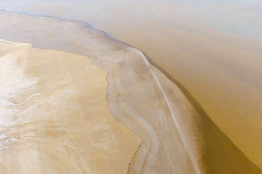 Aerial view of the vast Tuzbair salt flats with intricate patterns of dry earth and saline deposits in the Mangystau District Mangystau Region Kazakhstan.