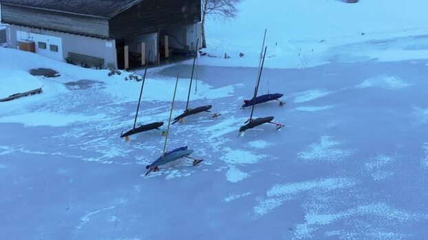 Aerial view of ice boats on frozen Lake Reschen Italy. Aerial view of ice boats on frozen Lake Reschen Italy.