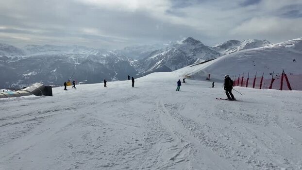 View of skiers on a snowy mountain slope Italy. View of skiers on a snowy mountain slope Italy.