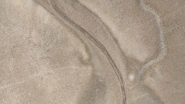 Aerial view of a completely dry river bed cutting through the parched arid landscape of the North West province highlighting the severe effects of drought in Bloemhof North West South Africa. Aerial view of a completely dry river bed cutting through the parched arid landscape of the North West province highlighting the severe effects of drought in Bloemhof North West South Africa.
