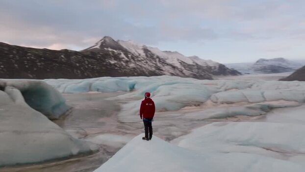 Aerial view of a person on a glacier in Iceland. Aerial view of a person on a glacier in Iceland.
