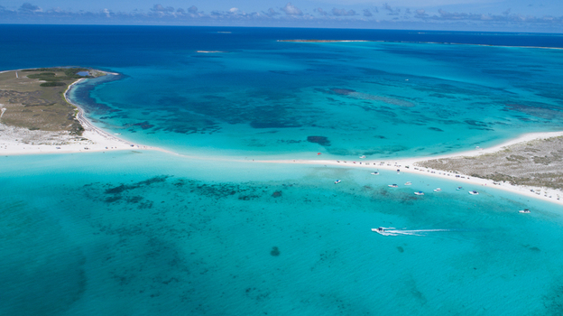 Aerial view of Los Roques archipelago with turquoise waters white sandbars and boats in the Caribbean Sea Los Roques Dependencias Federales Venezuela. Aerial view of Los Roques archipelago with turquoise waters white sandbars and boats in the Caribbean Sea Los Roques Dependencias Federales Venezuela.