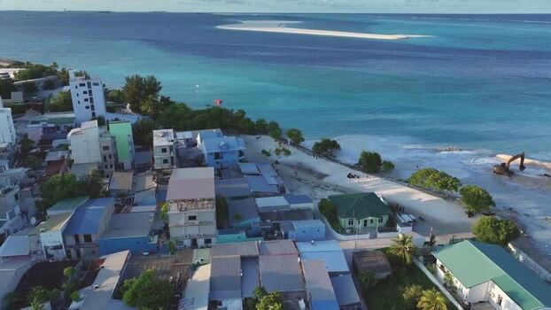 Aerial view of the coastal village of Gulhi and turquoise ocean Maldives Aerial view of the coastal village of Gulhi and turquoise ocean Maldives