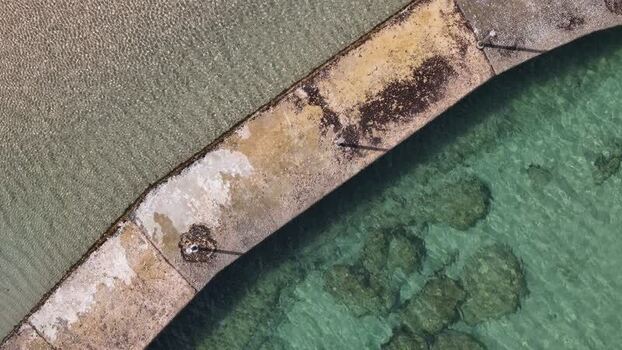 Aerial view of a weathered concrete pier and clear water Portugal. Aerial view of a weathered concrete pier and clear water Portugal.