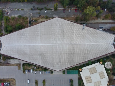 Aerial view of Universiada Hall with its distinctive diamond shaped roof and adjacent coffee shop surrounded by parking areas and greenery in Sofia Sofia City Province Bulgaria.