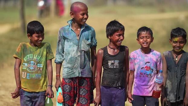 View of boys covered in Holi powder smiling in Dang Nepal.
