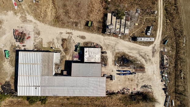 Aerial view of a farm with buildings trailers and various equipment scattered across the landscape Elkton Florida United States. Aerial view of a farm with buildings trailers and various equipment scattered across the landscape Elkton Florida United States.
