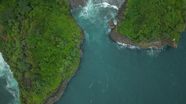 Aerial view of Sedahan Beach with lush cliffs Indonesia.