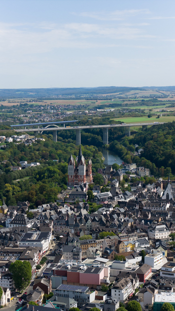 Aerial view of Limburg Cathedral surrounded by the historic old town the Lahn river and a modern bridge in Limburg an der Lahn Hessen Germany. Aerial view of Limburg Cathedral surrounded by the historic old town the Lahn river and a modern bridge in Limburg an der Lahn Hessen Germany.
