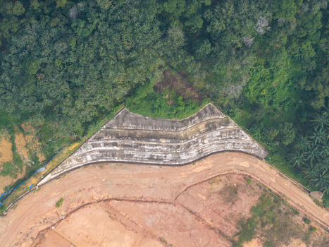 Aerial view of slope stabilization anchoring on a hillside with exposed earth and surrounding forest in Bukit Mertajam Penang Malaysia. Aerial view of slope stabilization anchoring on a hillside with exposed earth and surrounding forest in Bukit Mertajam Penang Malaysia.