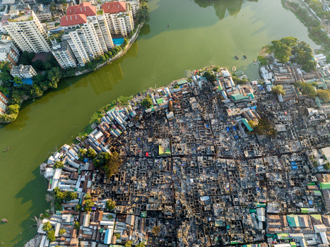 Aerial view of a sprawling cityscape contrasts with the serene waters of the lake reflecting the sky Dhaka Dhaka Division Bangladesh. Aerial view of a sprawling cityscape contrasts with the serene waters of the lake reflecting the sky Dhaka Dhaka Division Bangladesh.