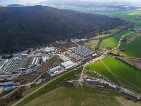 Aerial view of the industrial complex nestled between the verdant fields and the dark wooded mountains Detva Banskobystricky kraj Slovakia. Aerial view of the industrial complex nestled between the verdant fields and the dark wooded mountains Detva Banskobystricky kraj Slovakia.