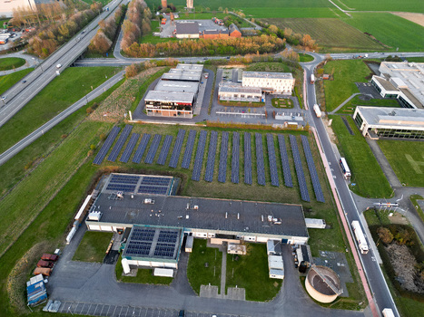 Aerial view of industrial buildings and solar panels basking in the soft glow of the setting sun Ath Wallonia Belgium. Aerial view of industrial buildings and solar panels basking in the soft glow of the setting sun Ath Wallonia Belgium.
