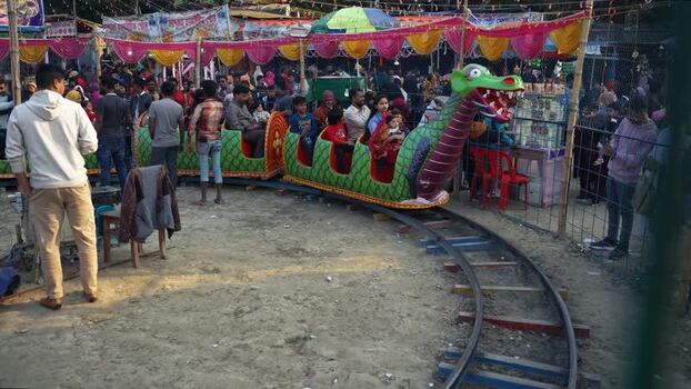 View of a dragon themed miniature train ride at a fair Bangladesh. View of a dragon themed miniature train ride at a fair Bangladesh.