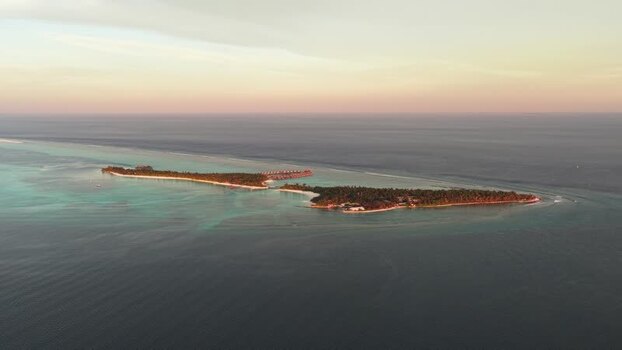 Aerial view of a tropical island resort at sunset Maldives. Aerial view of a tropical island resort at sunset Maldives.