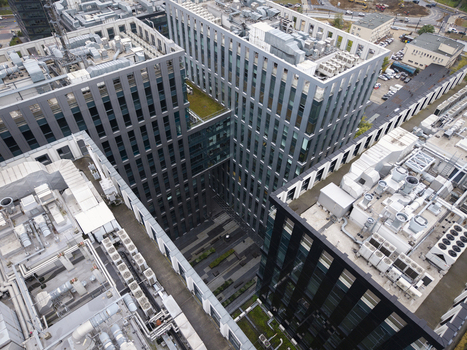 Aerial view of modern business park and office development with glass facades and rooftop HVAC units in Krakow Lesser Poland Voivode Poland.