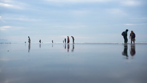 View of people on the reflective Cox s Bazar beach Bangladesh. View of people on the reflective Cox s Bazar beach Bangladesh.