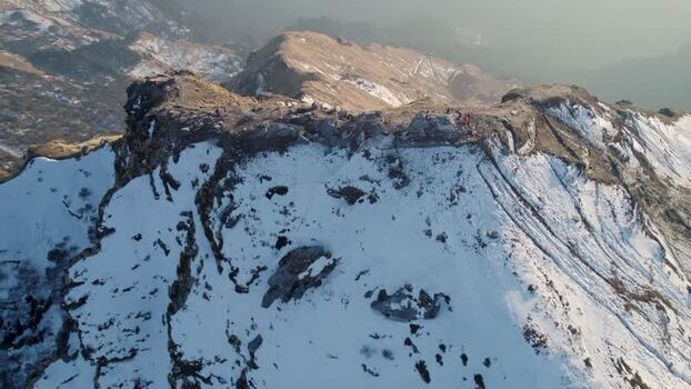 Aerial view of Tungnath temple on a snowy mountain ridge India.