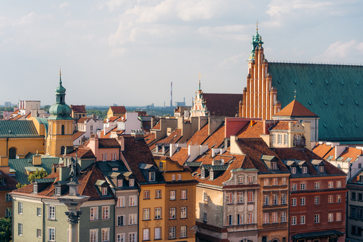 View of Warsaw Old Town with historic colorful buildings red tiled rooftops and the prominent St. John s Archcathedral under a clear sky in Warsaw Masovian Voivodeship Poland. View of Warsaw Old Town with historic colorful buildings red tiled rooftops and the prominent St. John s Archcathedral under a clear sky in Warsaw Masovian Voivodeship Poland.