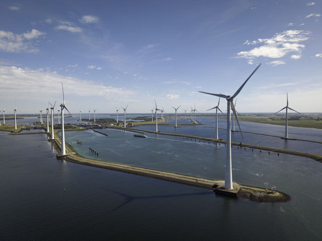 Aerial view of Grevelingendam wind farm with numerous wind turbines standing in the water along a narrow dam under a clear blue sky in Bruinisse Zeeland Netherlands. Aerial view of Grevelingendam wind farm with numerous wind turbines standing in the water along a narrow dam under a clear blue sky in Bruinisse Zeeland Netherlands.