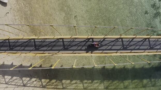 Aerial view of a motorbike crossing the Yellow Bridge Indonesia. Aerial view of a motorbike crossing the Yellow Bridge Indonesia.