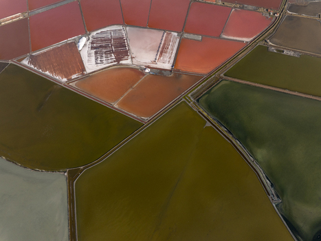 Aerial view of the salt pans featuring vibrant red and green evaporation ponds separated by narrow dikes Pomorie Burgas Bulgaria. Aerial view of the salt pans featuring vibrant red and green evaporation ponds separated by narrow dikes Pomorie Burgas Bulgaria.