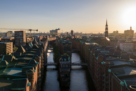 Aerial view of the Speicherstadt historic warehouse district with red brick buildings canals and the Elbphilharmonie at sunset in Hamburg Hamburg Germany. Aerial view of the Speicherstadt historic warehouse district with red brick buildings canals and the Elbphilharmonie at sunset in Hamburg Hamburg Germany.