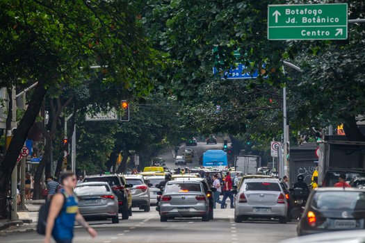 Rio de Janeiro Brazil 13 June 2026 View of urban traffic on a tree lined avenue with green directional signs pointing to Botafogo and Centro in the Copacabana district.