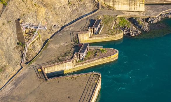 Aerial view of water intake and control structures beside a large hydroelectric dam reservoir in Rousset Serre Poncon Provence Alpes Cote d Azur France.