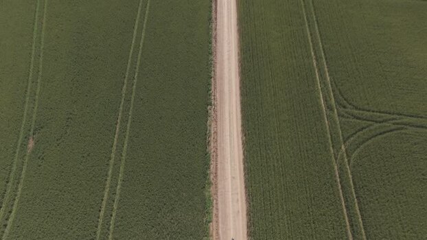 Aerial view of a dirt road through green fields South Africa. Aerial view of a dirt road through green fields South Africa.