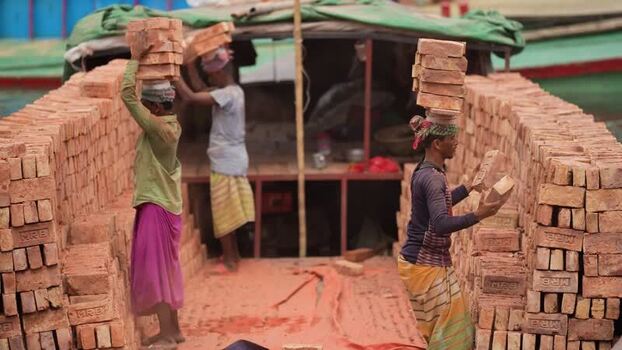 View of workers carrying bricks on their heads at Aminbazar Bangladesh. View of workers carrying bricks on their heads at Aminbazar Bangladesh.