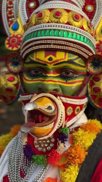 View of a traditional Theyyam performer with elaborate face paint India. View of a traditional Theyyam performer with elaborate face paint India.